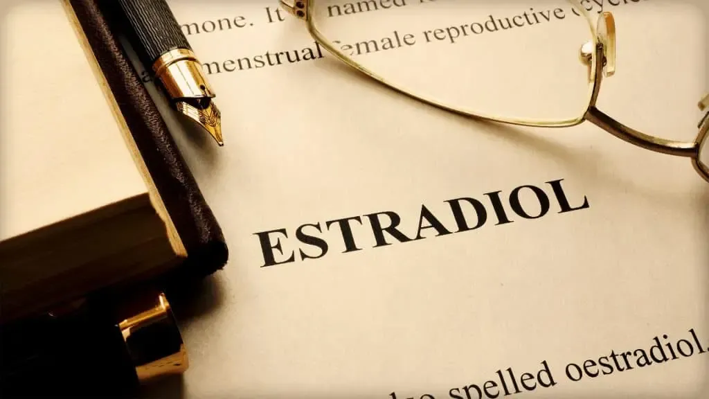 The word "estradiol" is written on a piece of paper, indicating hormone levels.