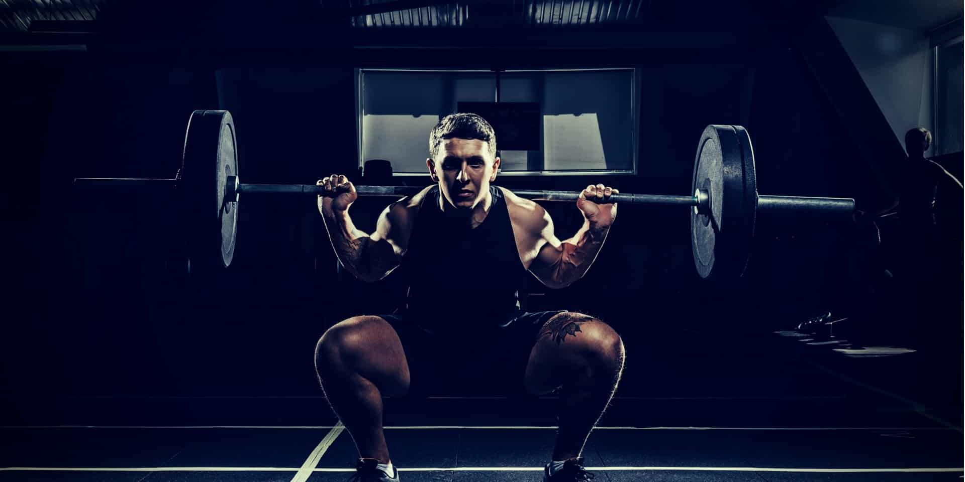 Compound Lifts or Isolation Exercises sportsman lifting a barbell