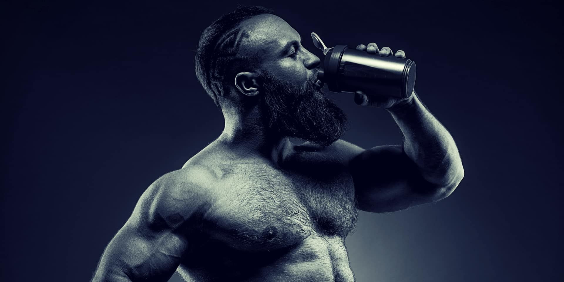 Pine Pollen Benefits bearded Man bodybuilder posing on gray background